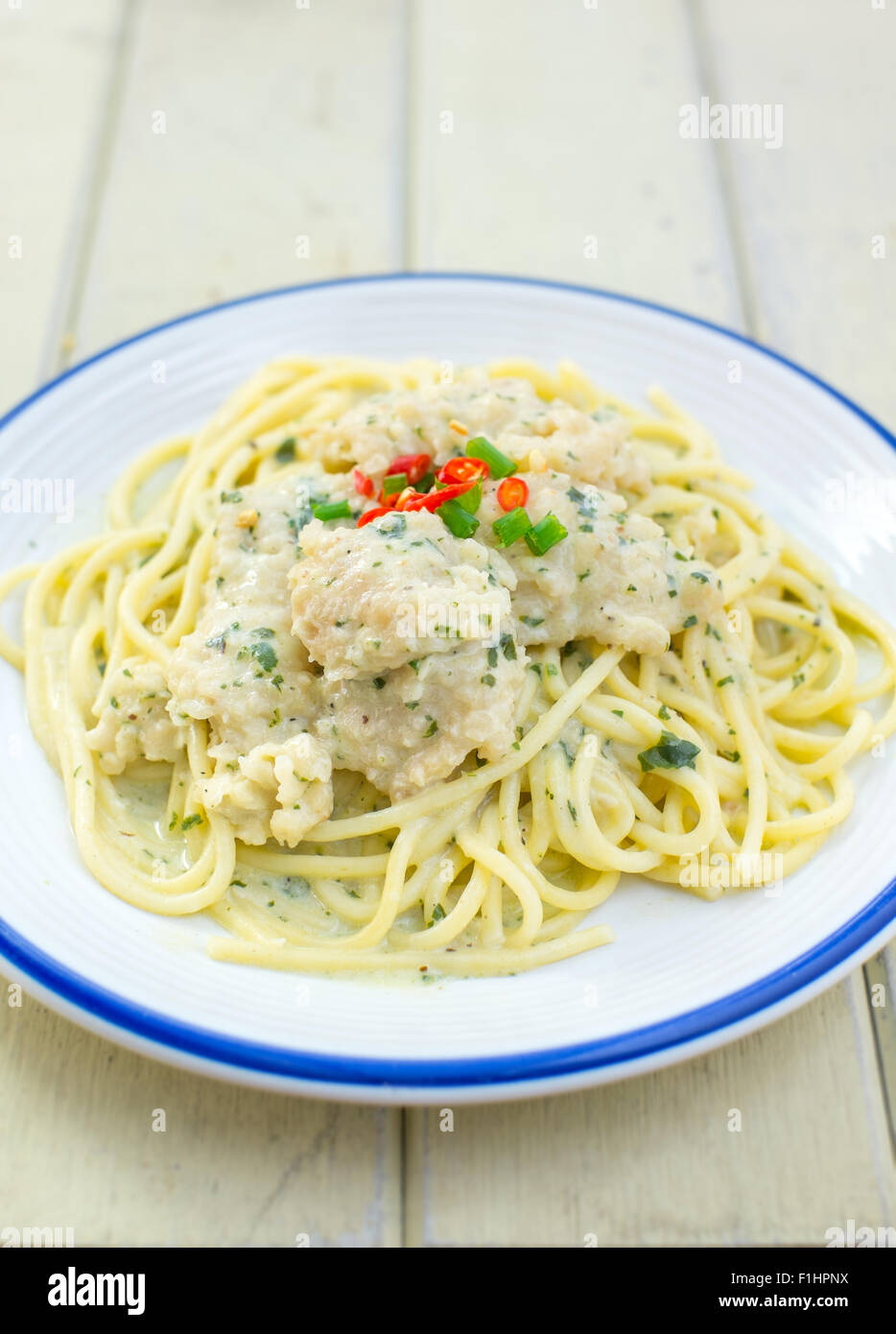 spaghetti white sauce with fried fish Stock Photo - Alamy