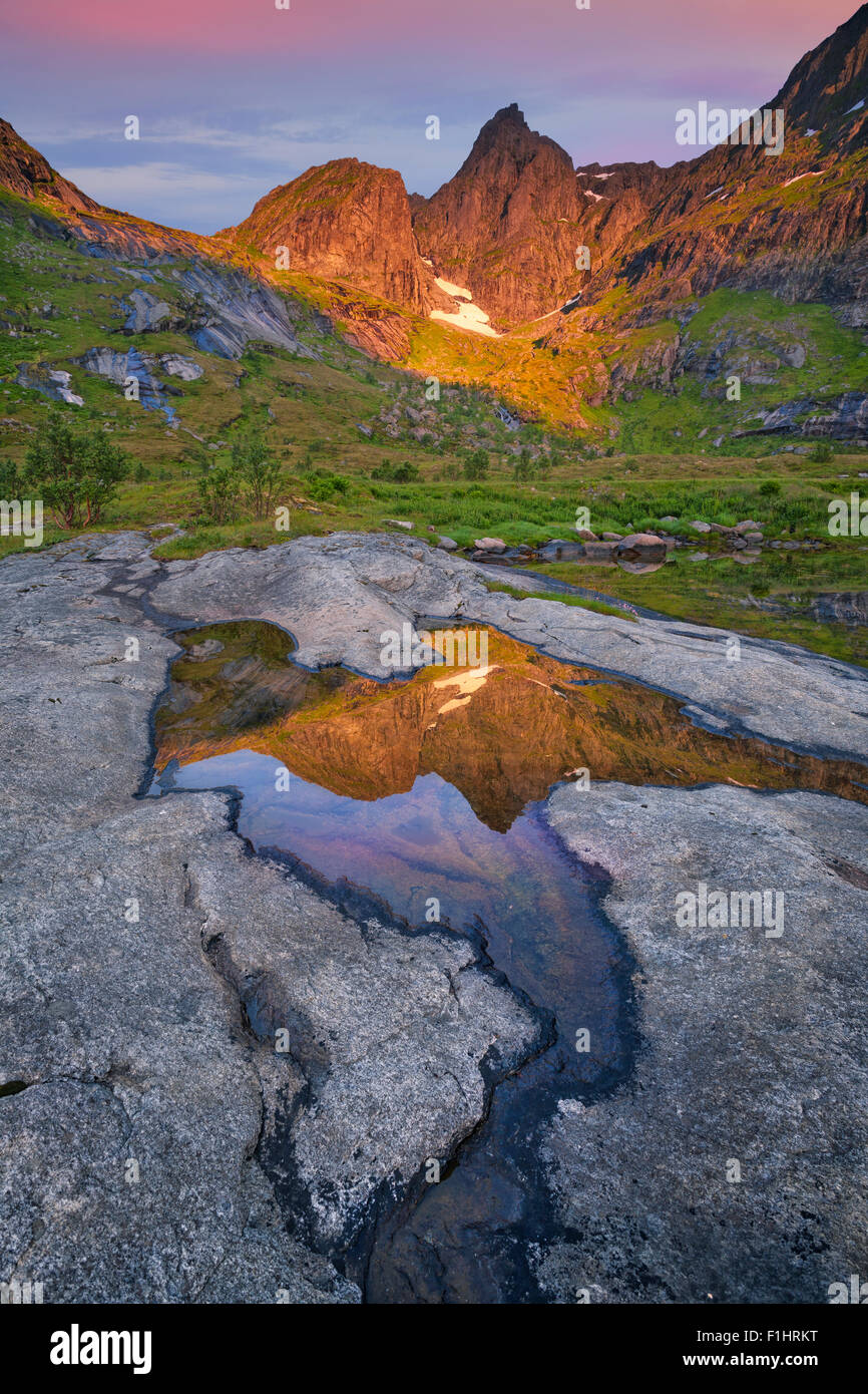 Image of mountain range located at Lofoten islands in Norway during sunrise. Stock Photo