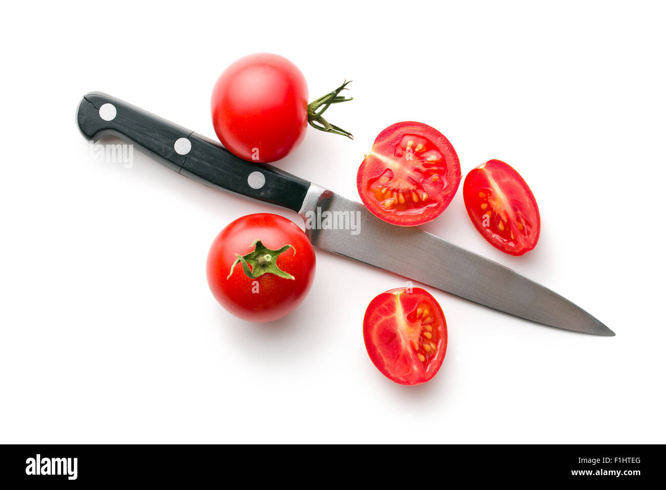 chopped tomatoes and knife on white background Stock Photo - Alamy