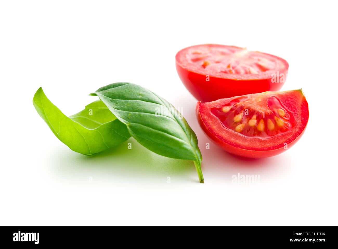 chopped tomatoes and basil leaf on white background Stock Photo - Alamy