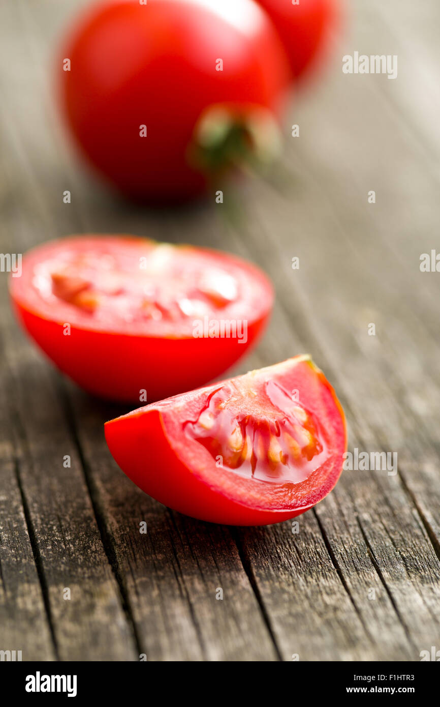 chopped tomatoes on old wooden table Stock Photo - Alamy