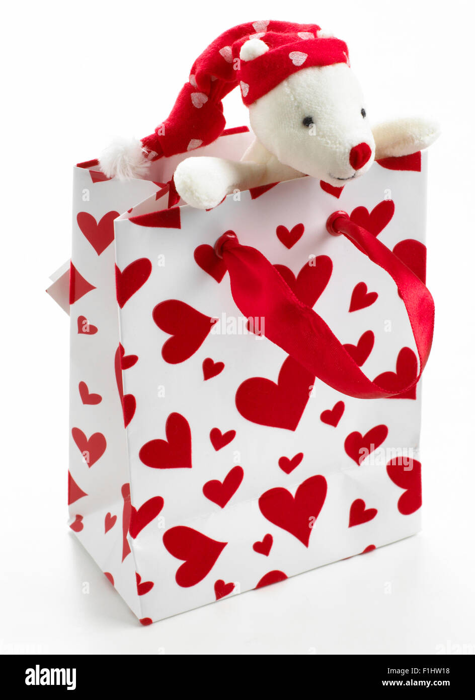 Teddy bear in bag with hearts on Stock Photo
