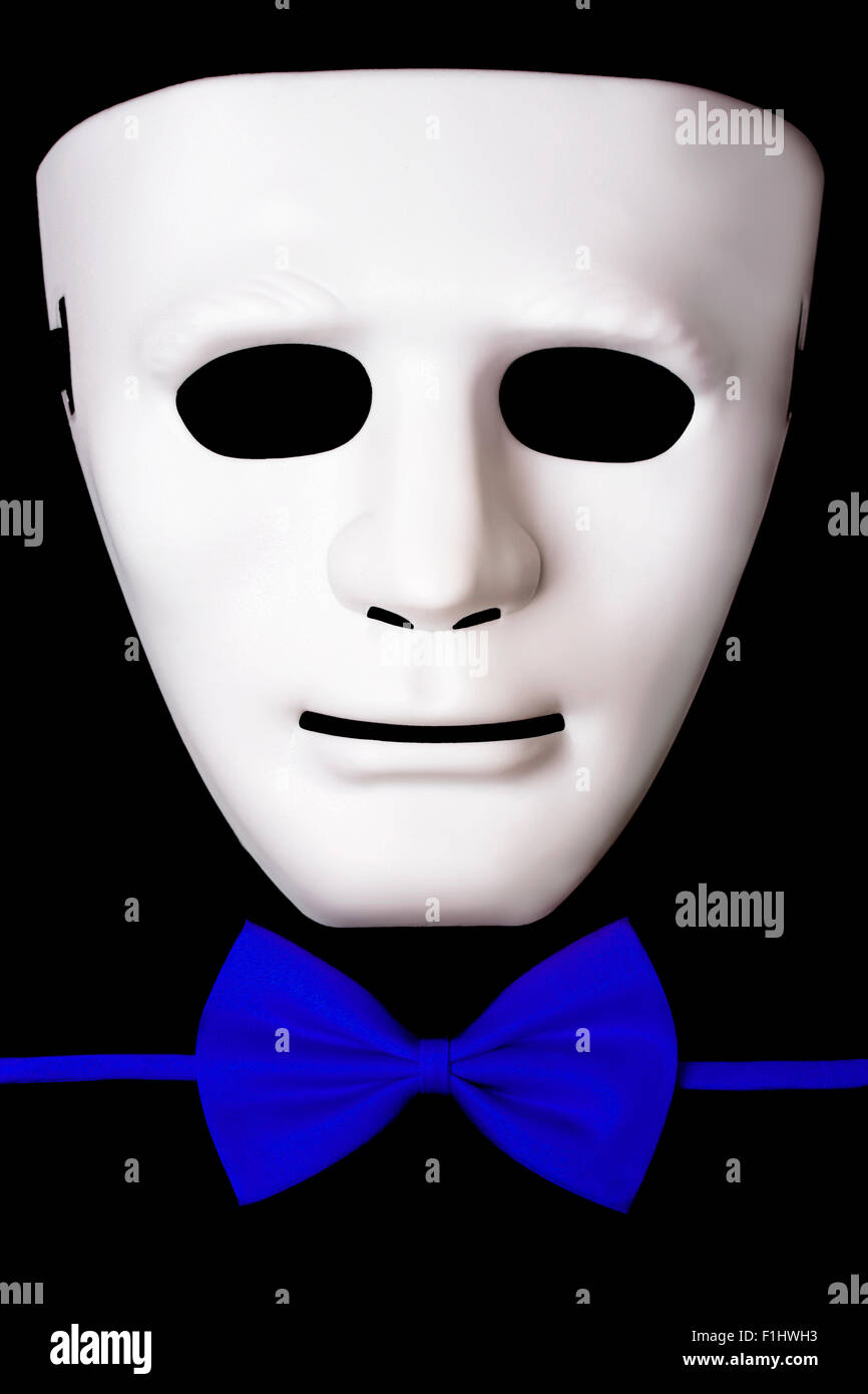 White mask and blue bow tie isolated on black background Stock Photo