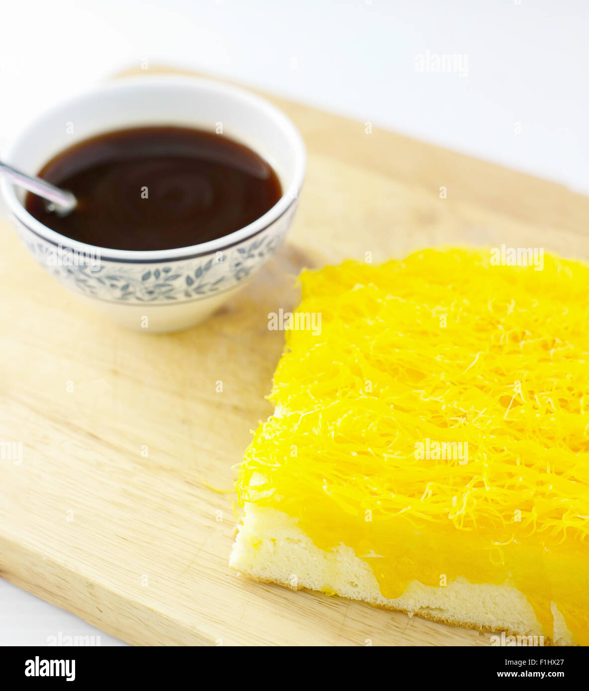 Golden thread (Foythong Cake) and hot coffee on wooden background Stock Photo