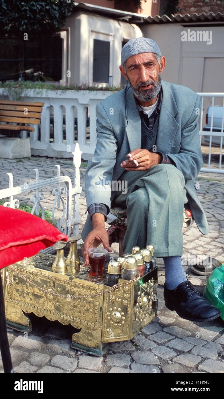 Shoe-shine Man in Istanbul, sitting having a drink waiting for customers Stock Photo