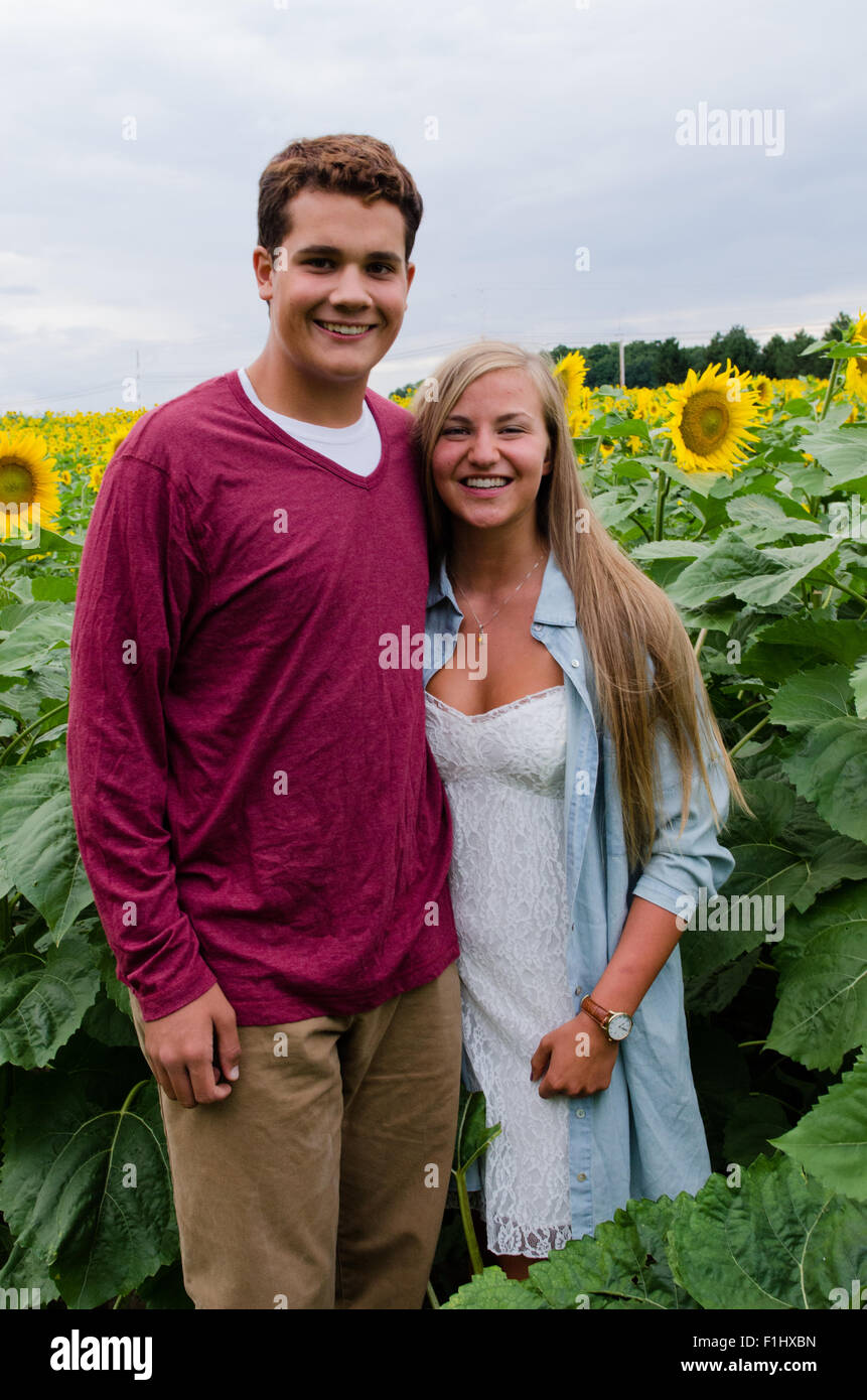 young couple posing for photo in sunflower field Stock Photo - Alamy