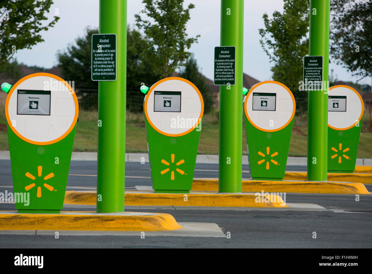 A logo sign outside of a Walmart Pickup Grocery location in Bentonville, Arkansas on August 17