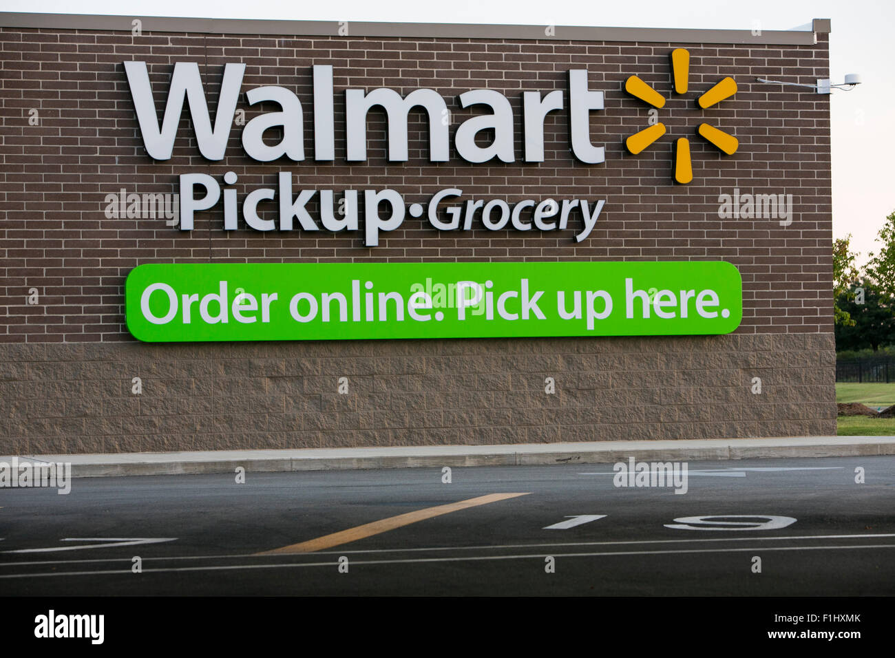A logo sign outside of a Walmart Pickup Grocery location in