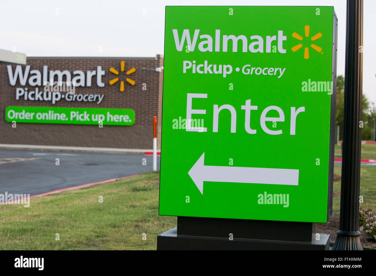 A logo sign outside of a Walmart Pickup- Grocery location in Bentonville, Arkansas on August 17, 2015. Stock Photo