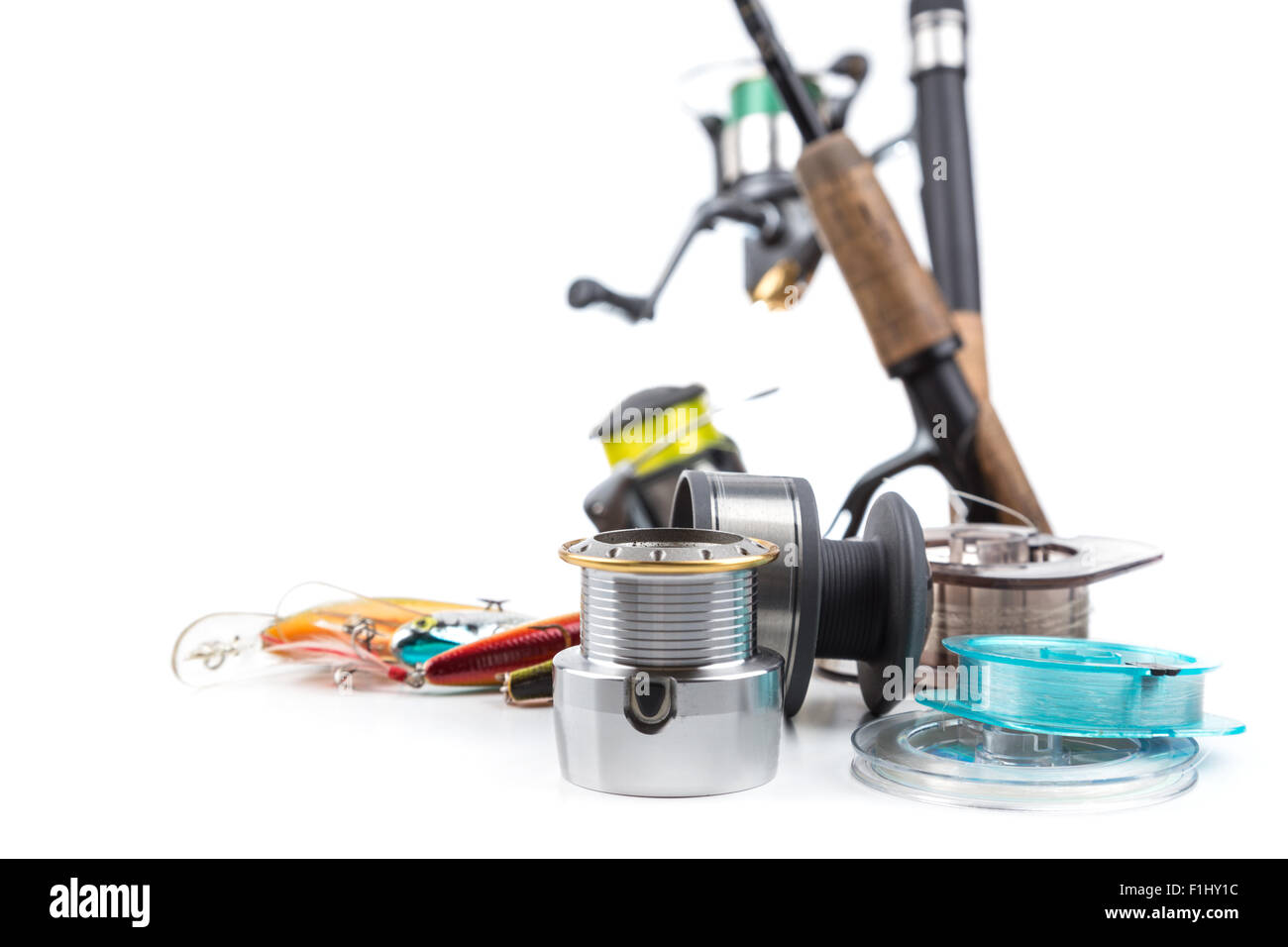 different fishing tackles rod, reel, line and lures on white