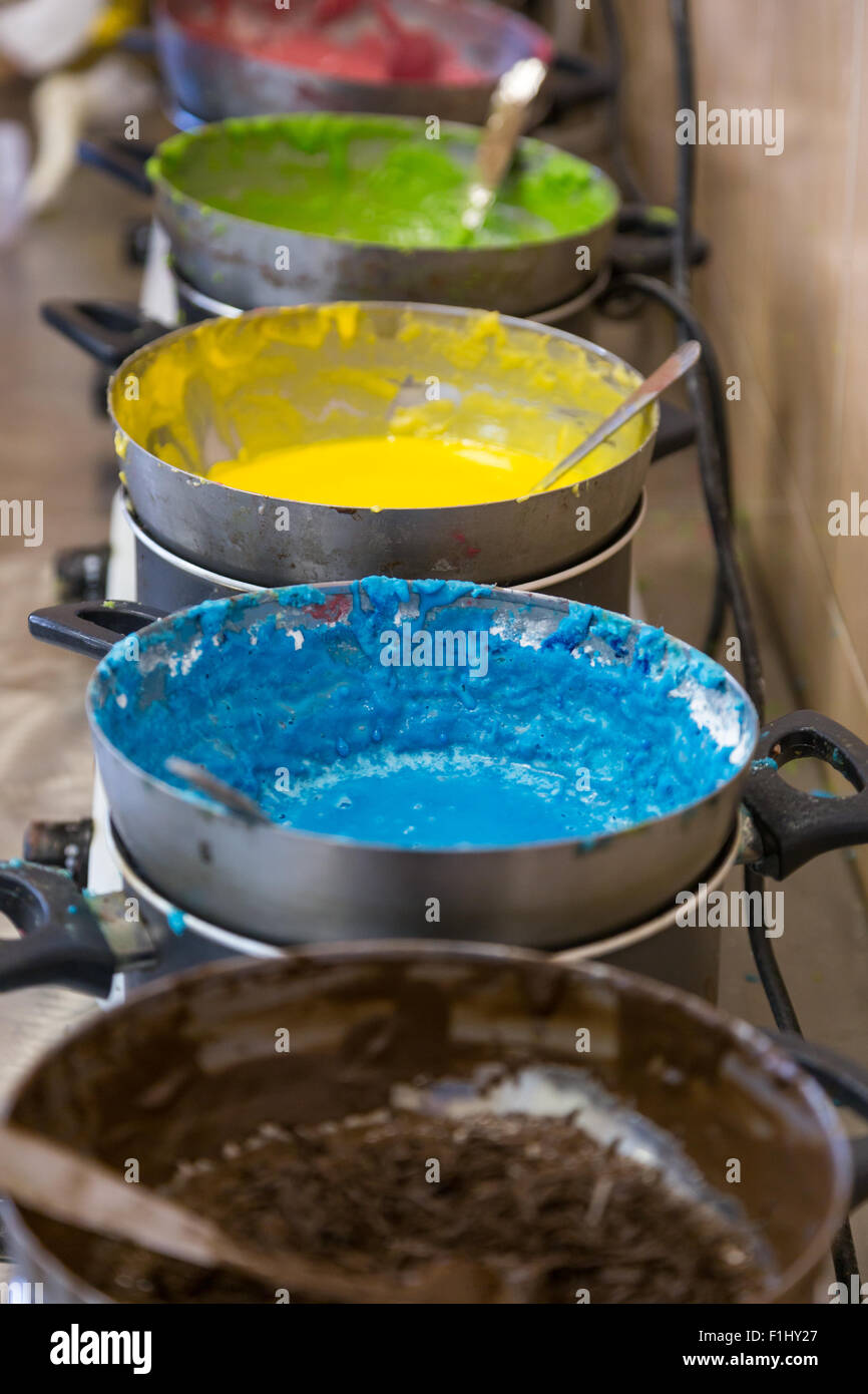 vertical line glazed assorted colors in bowl on kitchen range Stock Photo