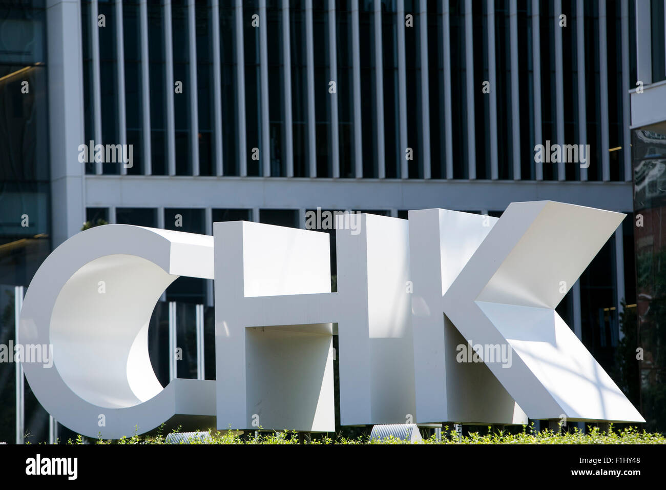 A logo sign outside of the headquarters of the Chesapeake Energy Corporation, in Oklahoma City, Oklahoma, on August 20, 2015. Stock Photo