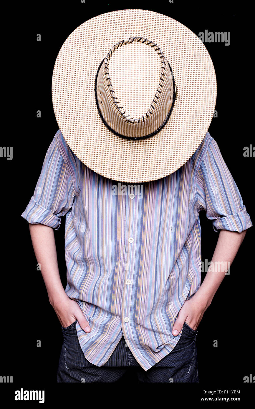 A cowboy is hiding behind his hat Stock Photo Alamy