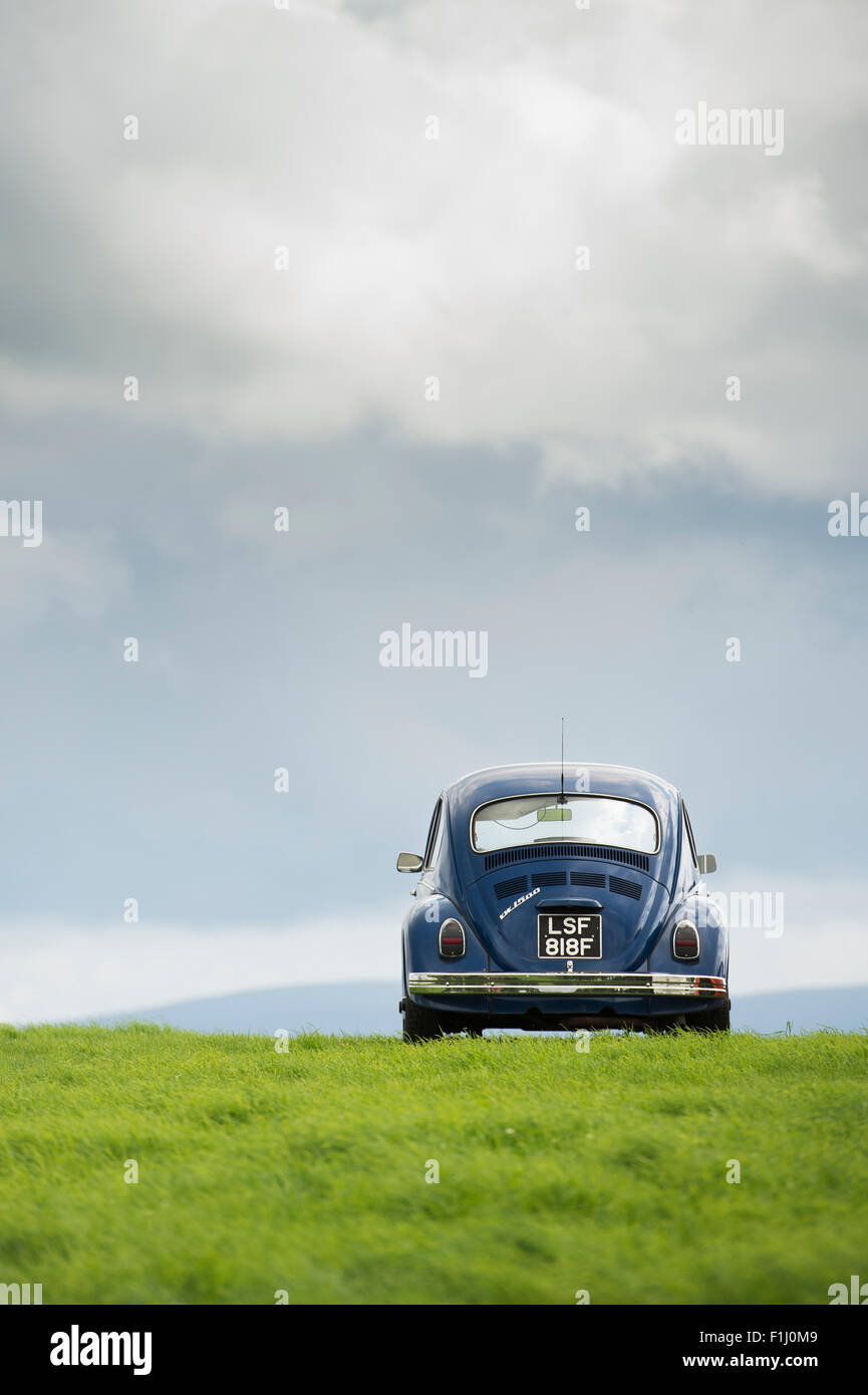 1968 VW Beetle car on a hill against a stormy sky in the scottish borders.  Scotland Stock Photo