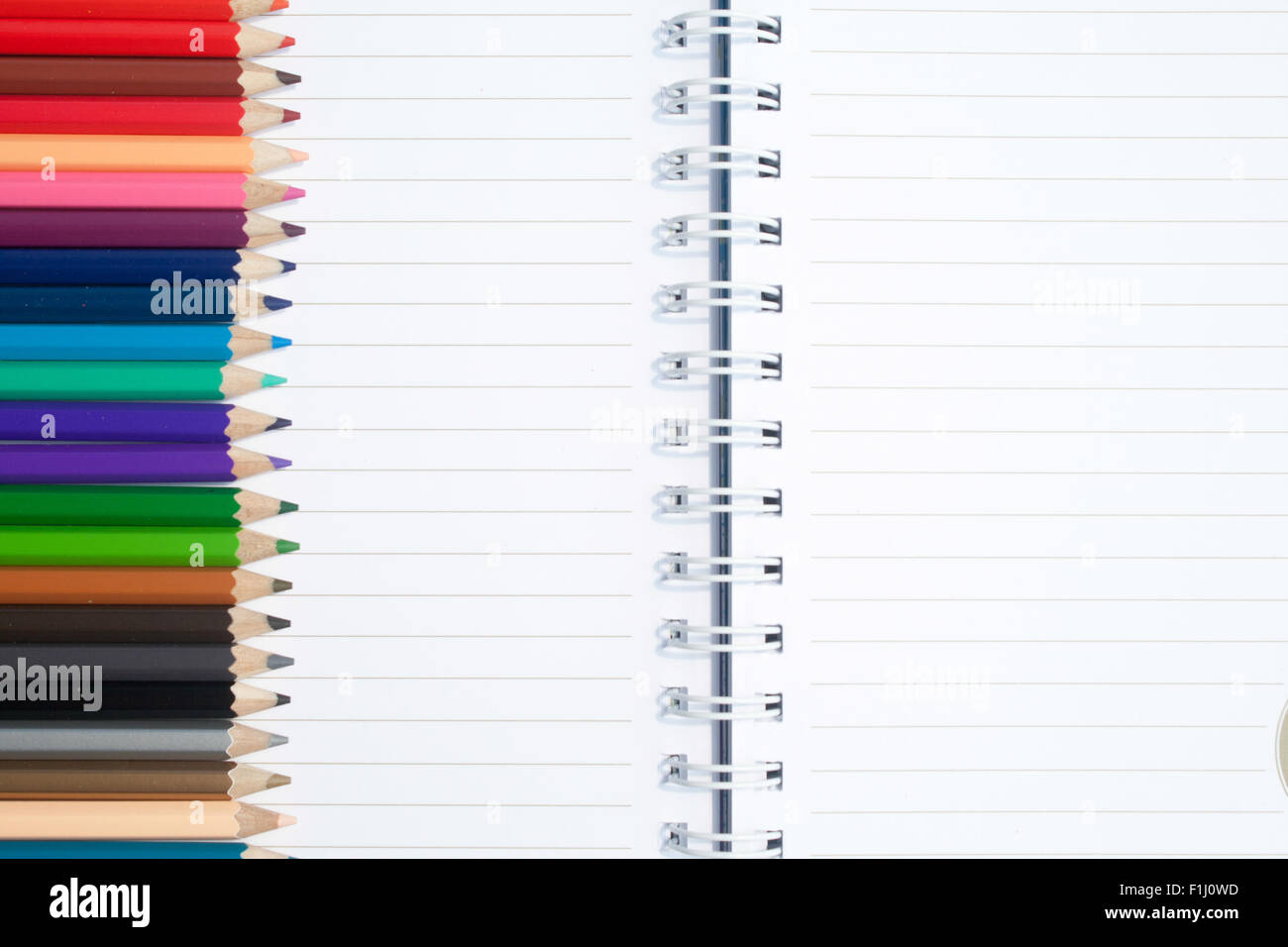 Note book and colored pencils Stock Photo Alamy