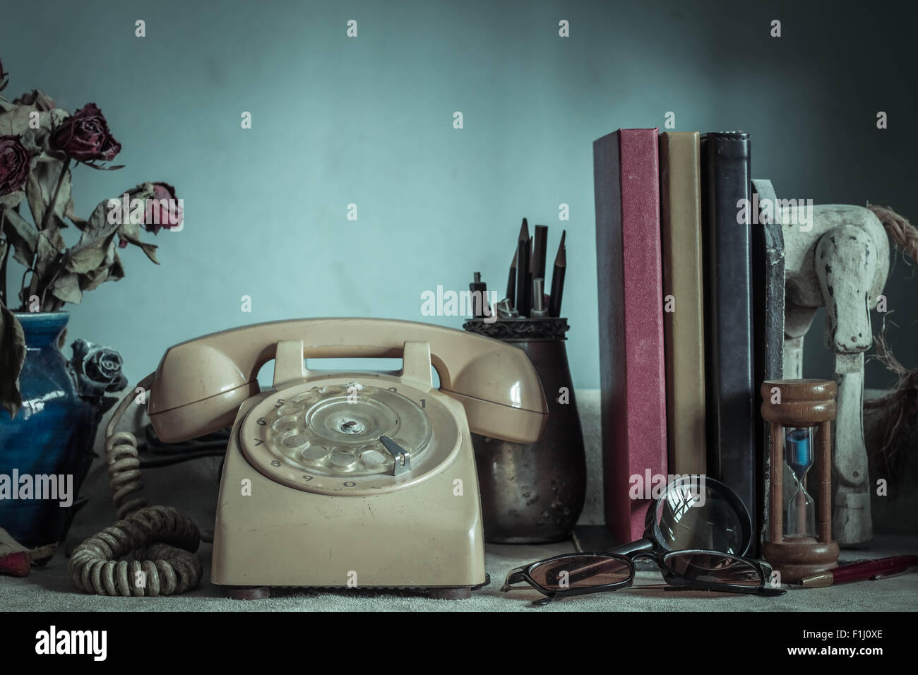 Old phone on the table and working with vintage images. Stock Photo