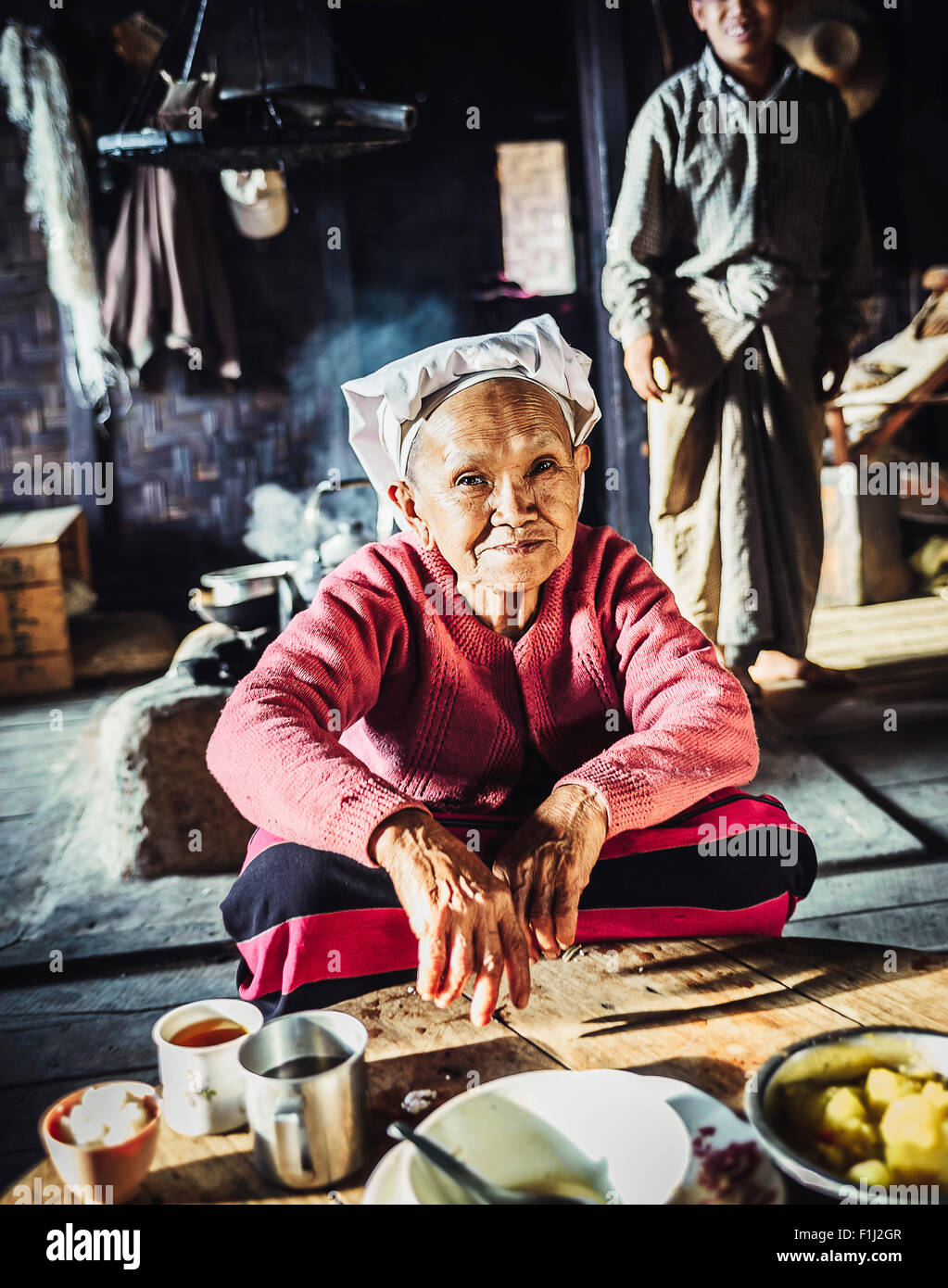 Palaung woman serving tea in Omshan Burma, Stock Photo