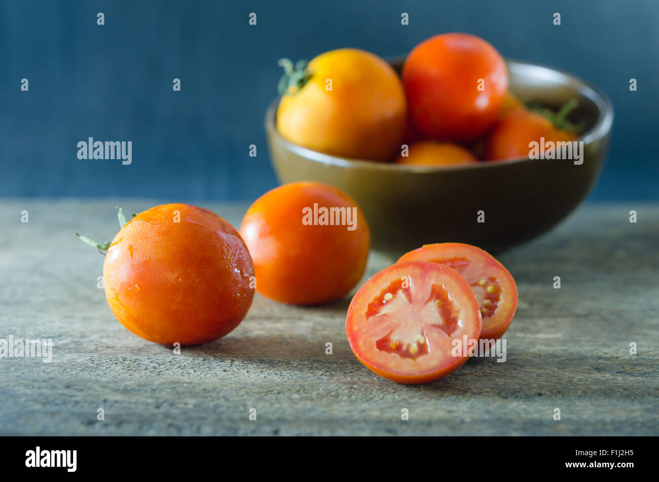 red ripe  vegetable , tomato over  wooden table Stock Photo