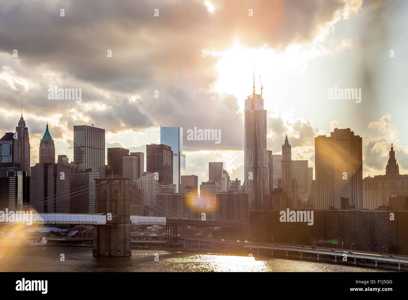 Bright Dramatic View of Downtown Manhattan with sun flare effect and warm toning Stock Photo