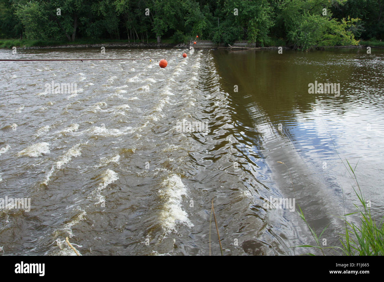 Low water levels and roller waves on the Fox River at the low head dam at Princeton. Stock Photo