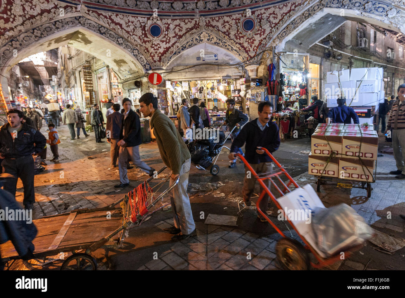 Men carrying goods in the Grand Bazaar also known as Tehran's Grand Bazaar is a historical market Tehran. Stock Photo