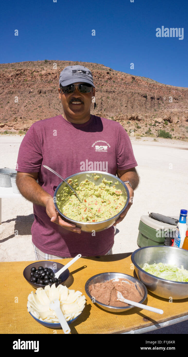Mexico, Baja, Lapaz, Espiritu Santo. Worker preparing meal. Stock Photo