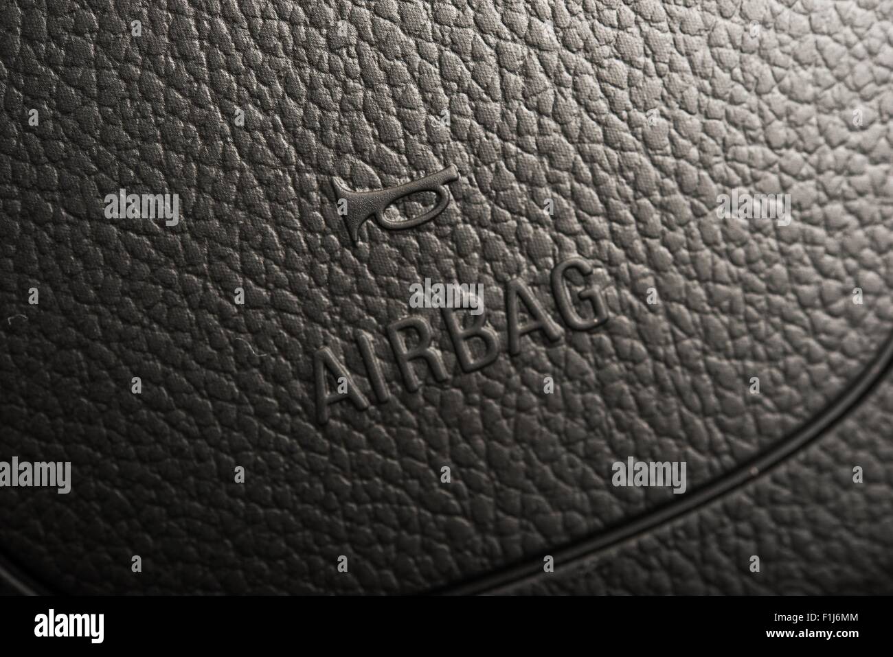 Steering Wheel Airbag Symbol Closeup Photo. Car Safety Feature Stock