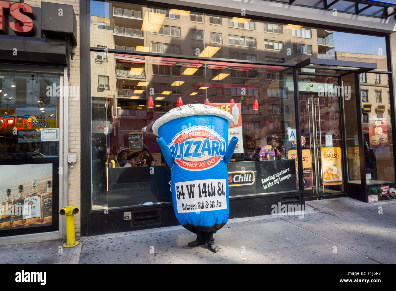 A worker dressed in a Dairy Queen Blizzard costume entices hot passer by into the Dairy Queen Grill & Chill fast casual restaurant in Manhattan in New York on Saturday, August 29, 2015.  (© Richard B. Levine) Stock Photo