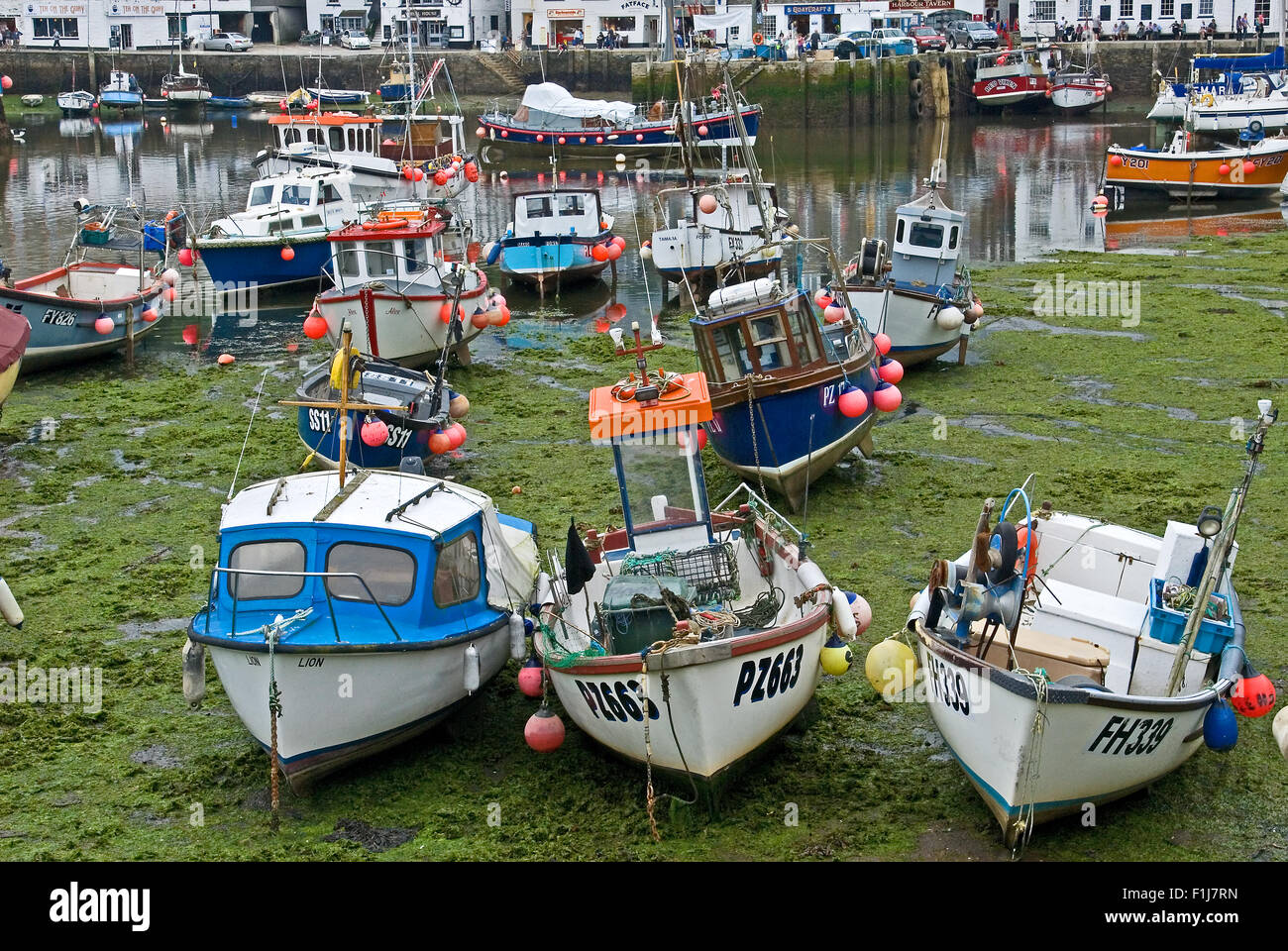 Mevagissey harbour with fishing boats at low tide Stock Photo - Alamy