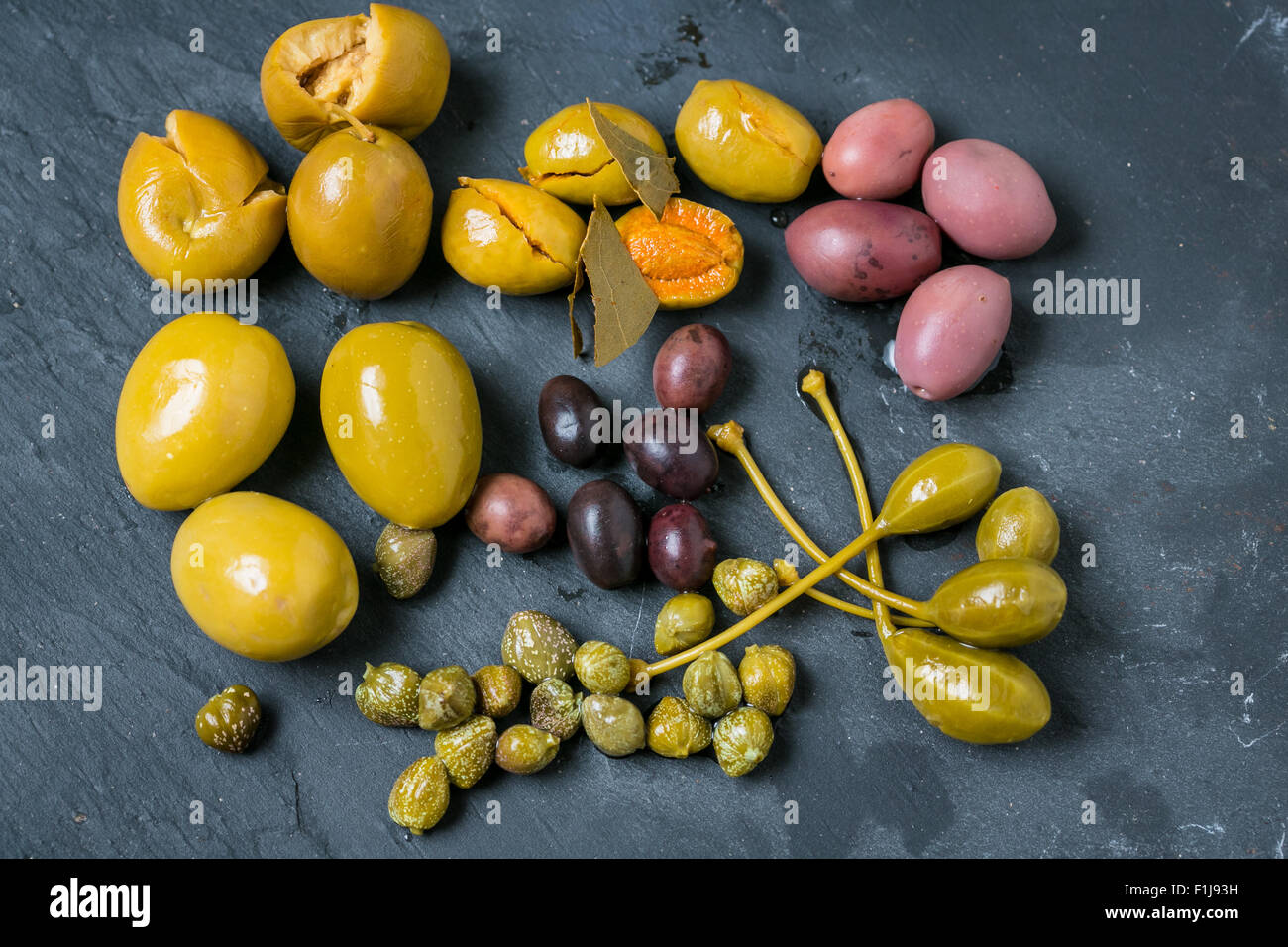 Mixed olives on grey background Stock Photo