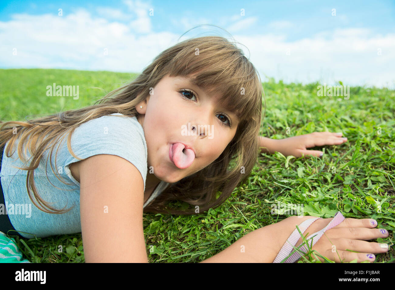 Beautiful portrait of a little girl outside on grass Stock Photo - Alamy