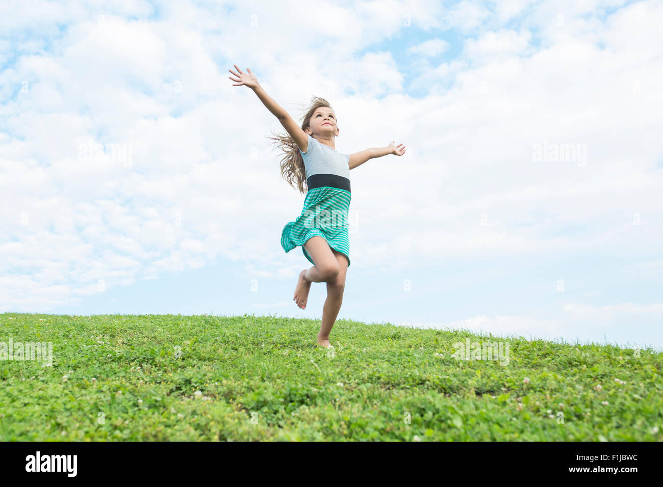 Beautiful portrait of a little girl outside on grass Stock Photo - Alamy