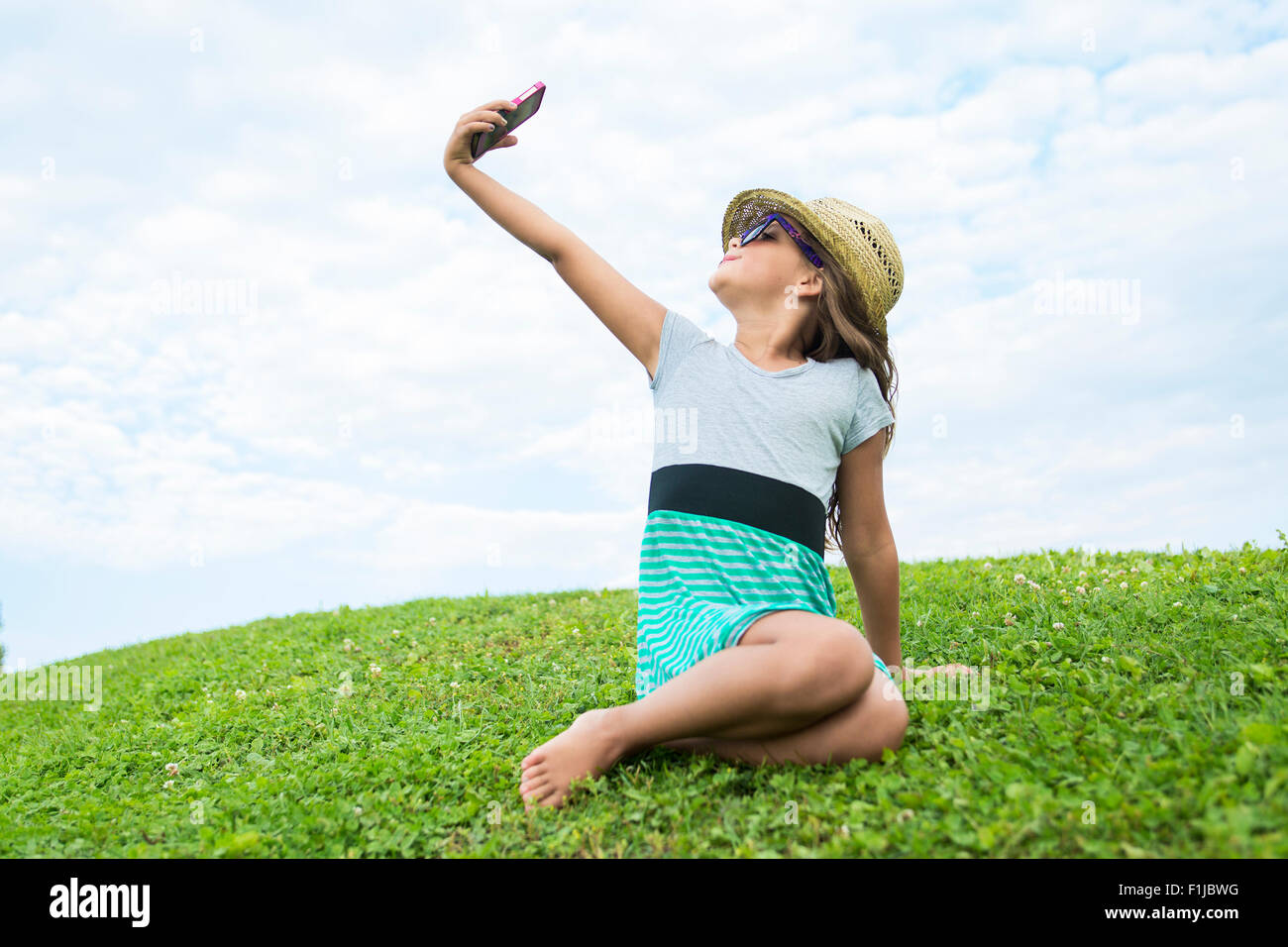 Beautiful portrait of a little girl outside on grass Stock Photo - Alamy