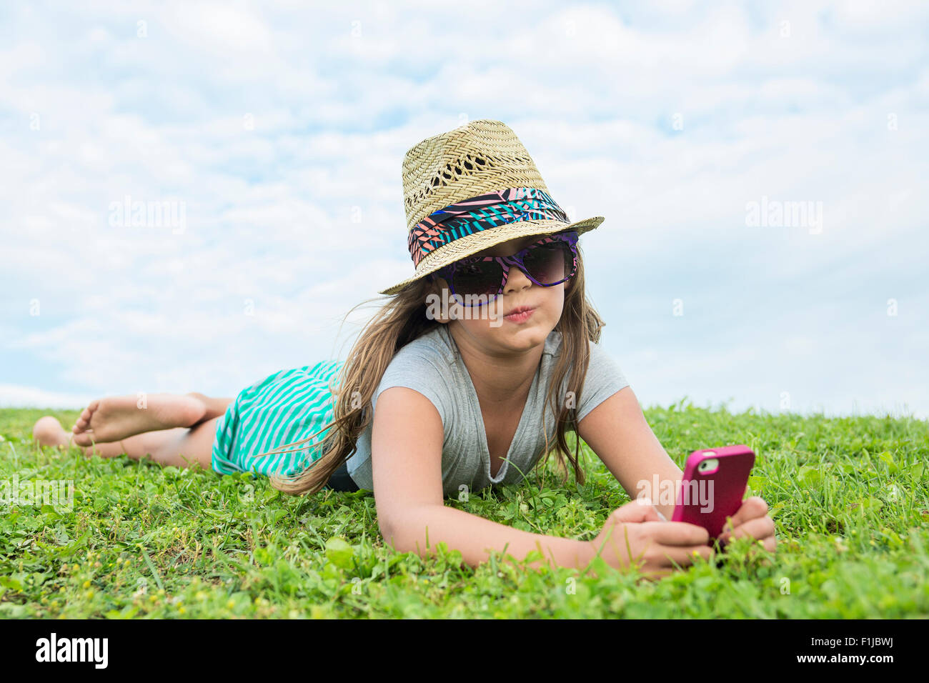 Beautiful portrait of a little girl outside on grass Stock Photo