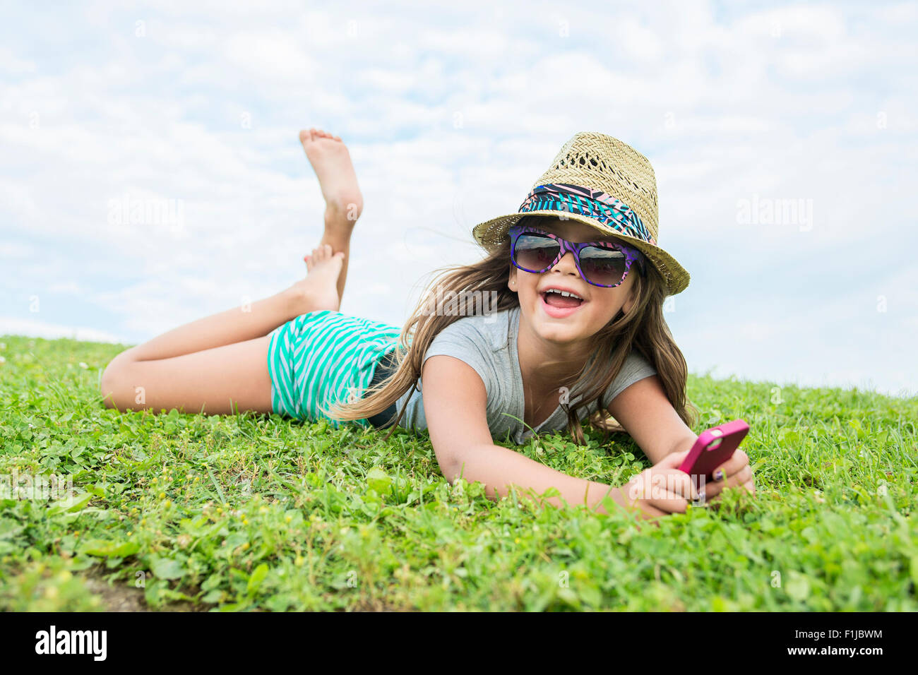 Beautiful portrait of a little girl outside on grass Stock Photo