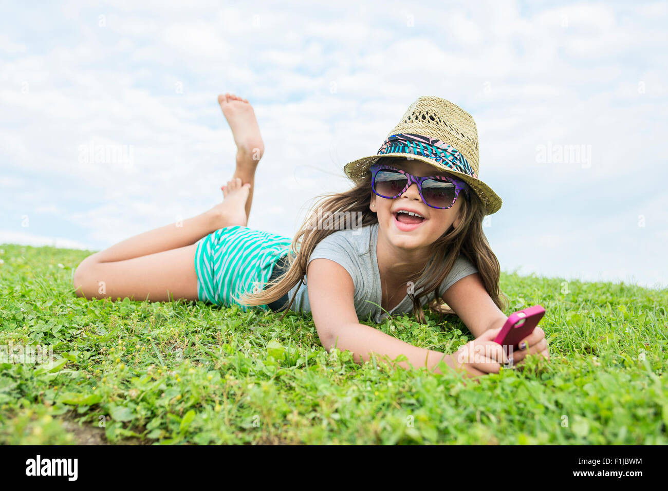 Beautiful portrait of a little girl outside on grass Stock Photo - Alamy