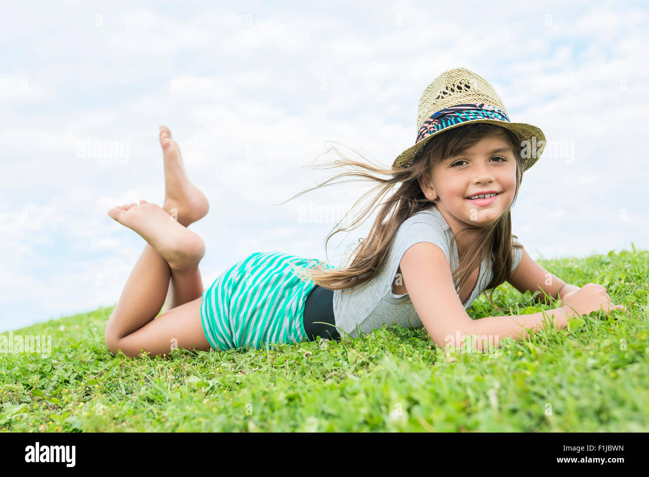 Beautiful portrait of a little girl outside on grass Stock Photo - Alamy