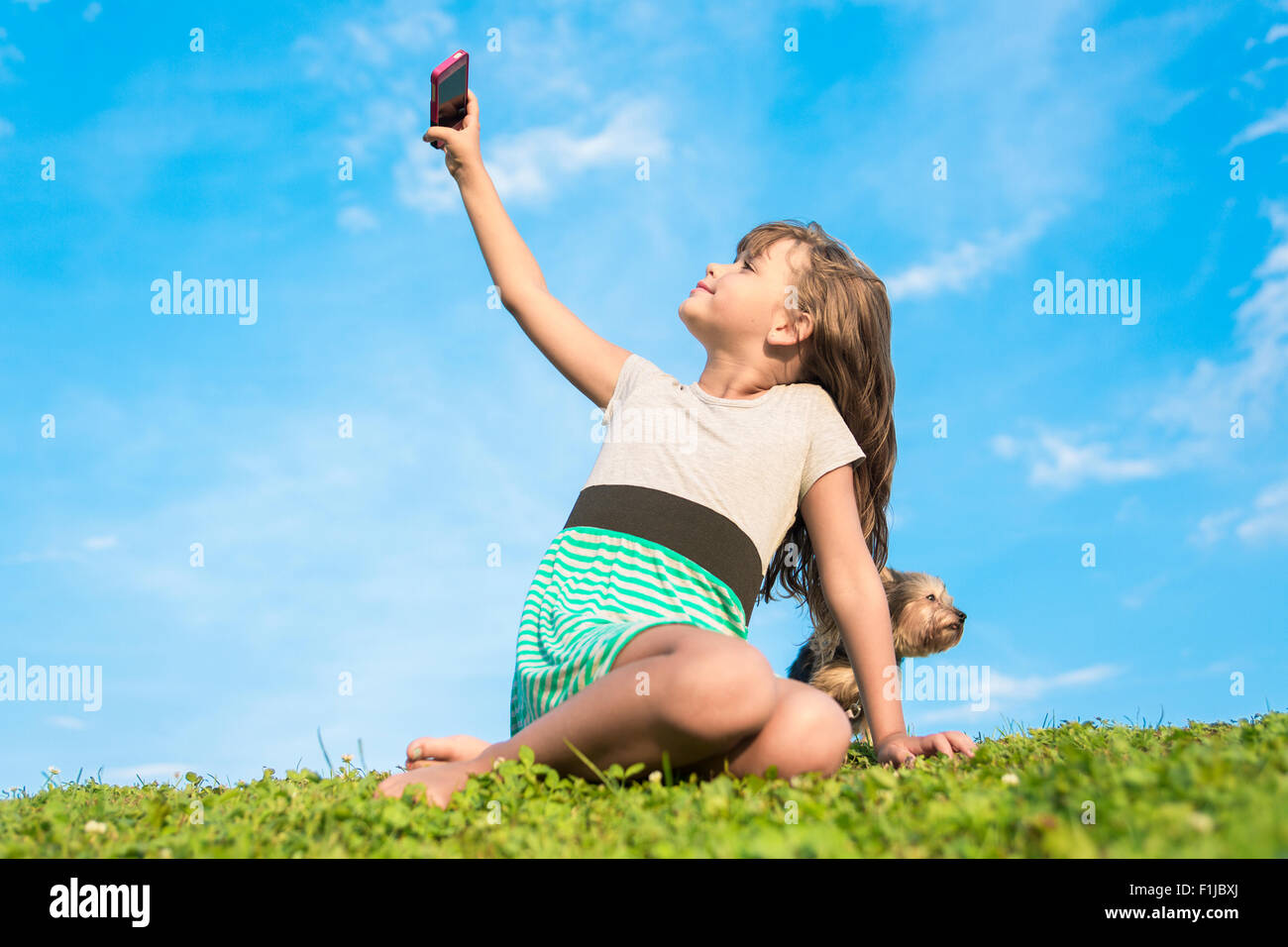 Beautiful portrait of a little girl outside on grass Stock Photo - Alamy