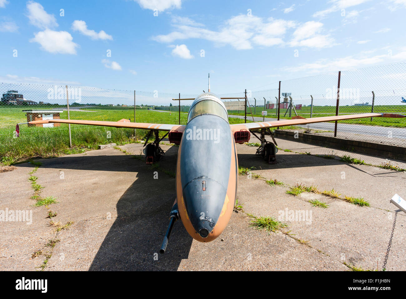 Manston airport museum. PZL Mielec TS-11 Iskra, a Polish jet trainer, on concrete airport apron in bright sunshine. Wide angle, facing nose cone. Stock Photo