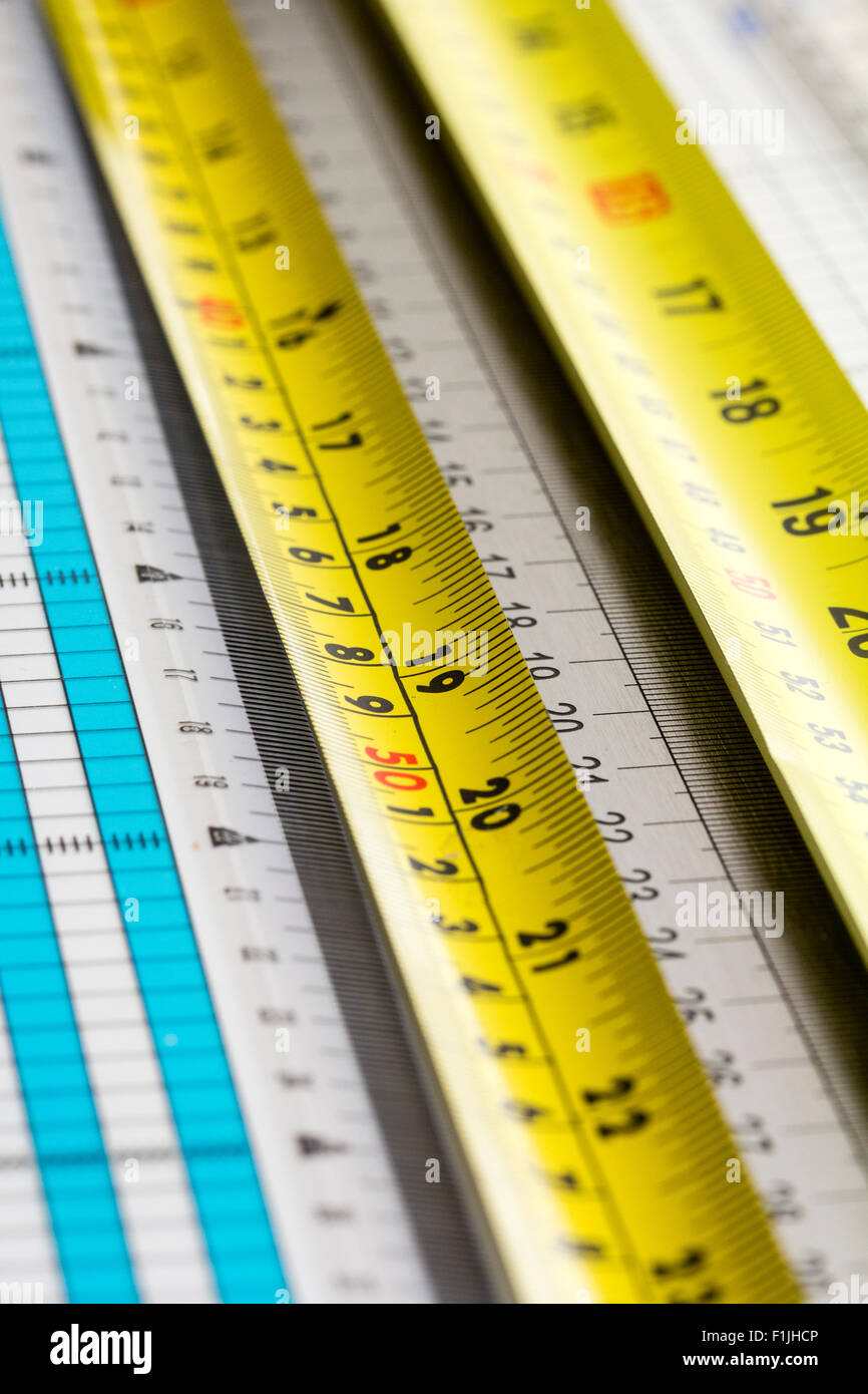 Overhead view of several different rulers and metal tape measures ...