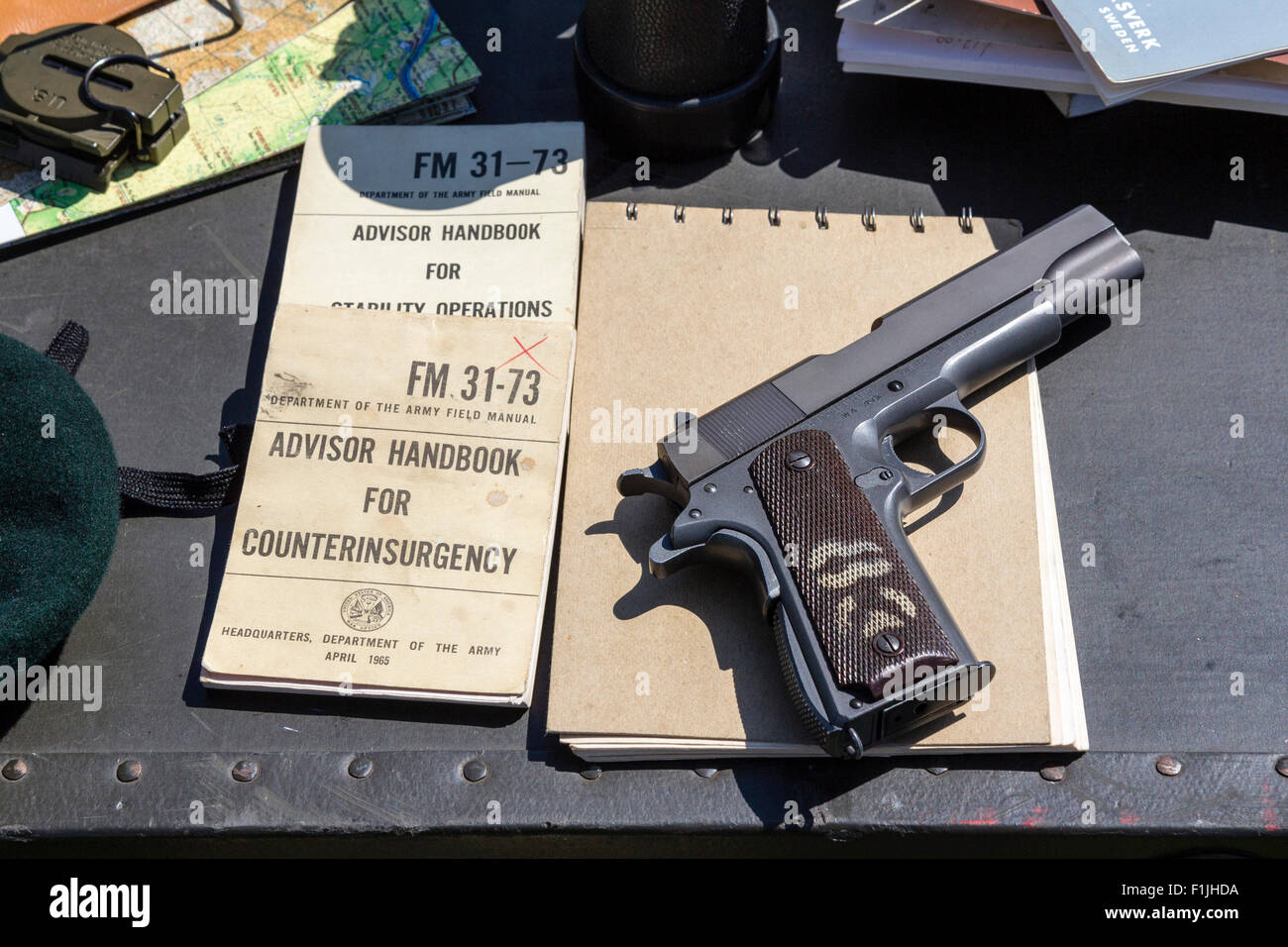 Colt 45 Revolver and counterinsurgency handbook on table - Stock Image
