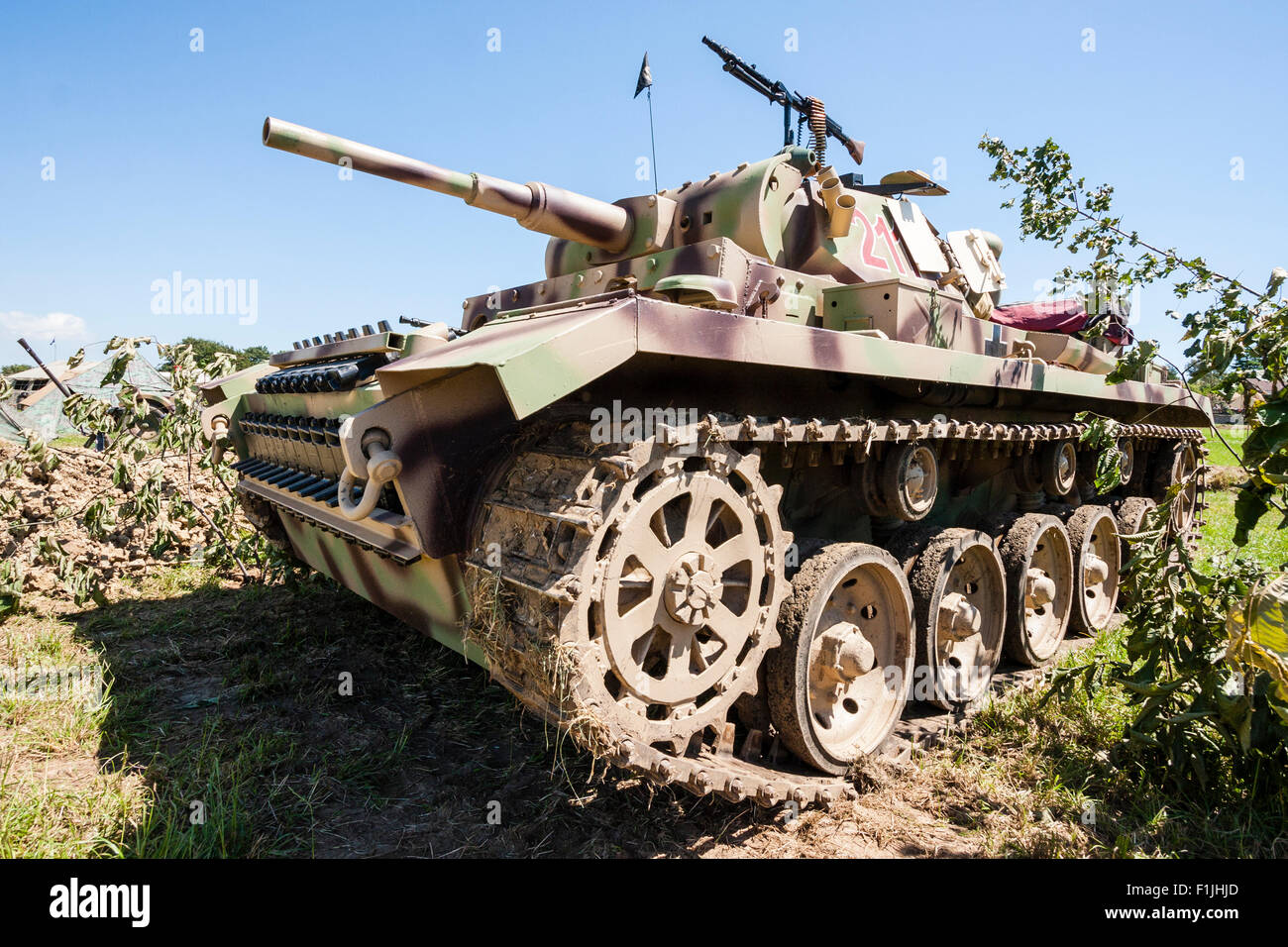 Living history re-enactment of world war two. A German Panzer IV medium tank . Close up with tank filling frame. Parked on grass, with blue sky. Stock Photo