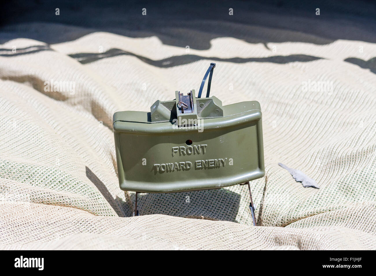 Vietnam re-enactment. American M18 anti-personnel Claymore mine positioned on ground with the M57 firing device, commonly called the 'clacker' Stock Photo