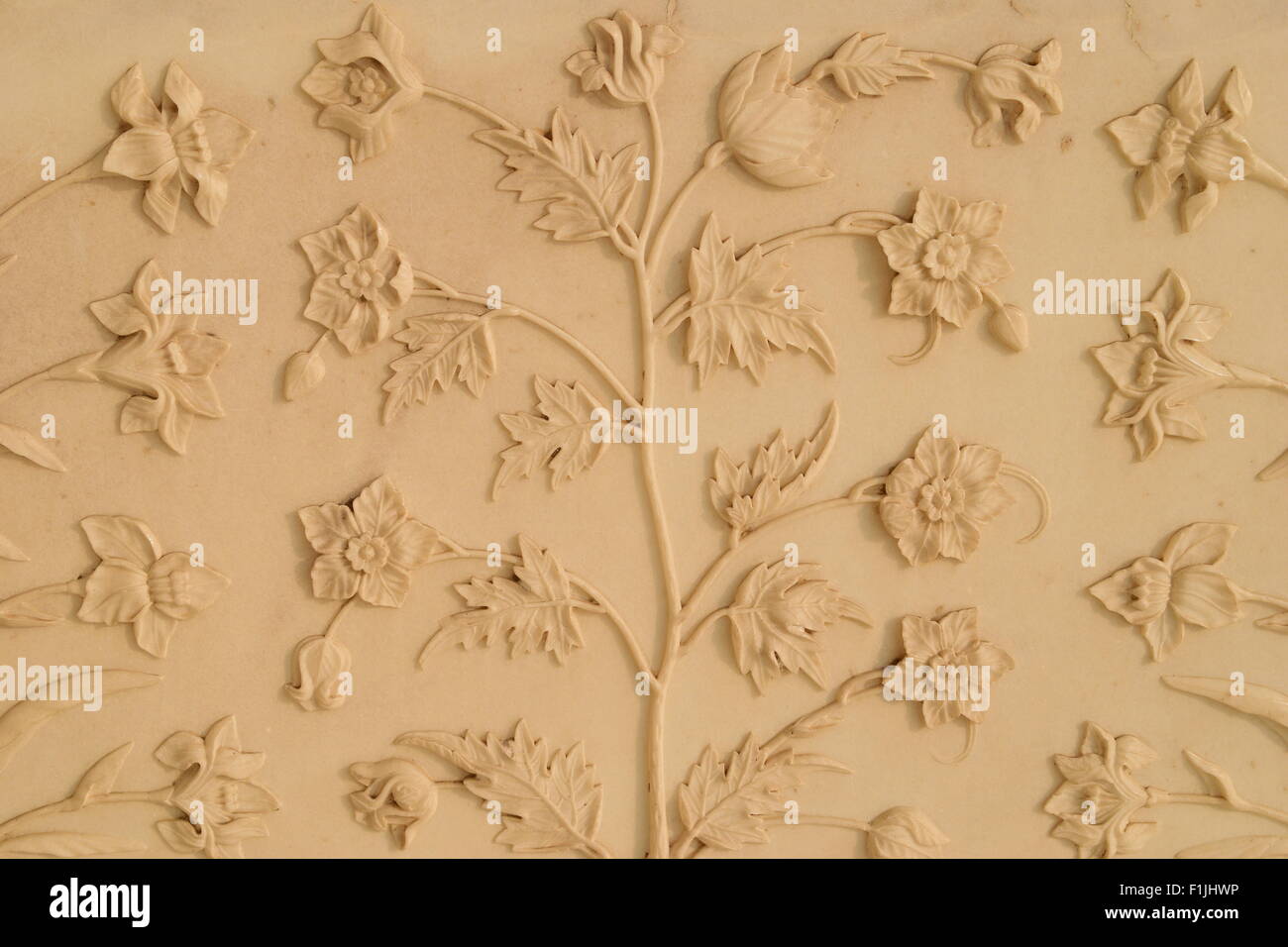 Flowers art design carved in Marble walls of Taj mahal Agra India ( world wonder Taj Mahal India ) Marble carving design floral pattern detail view Stock Photo