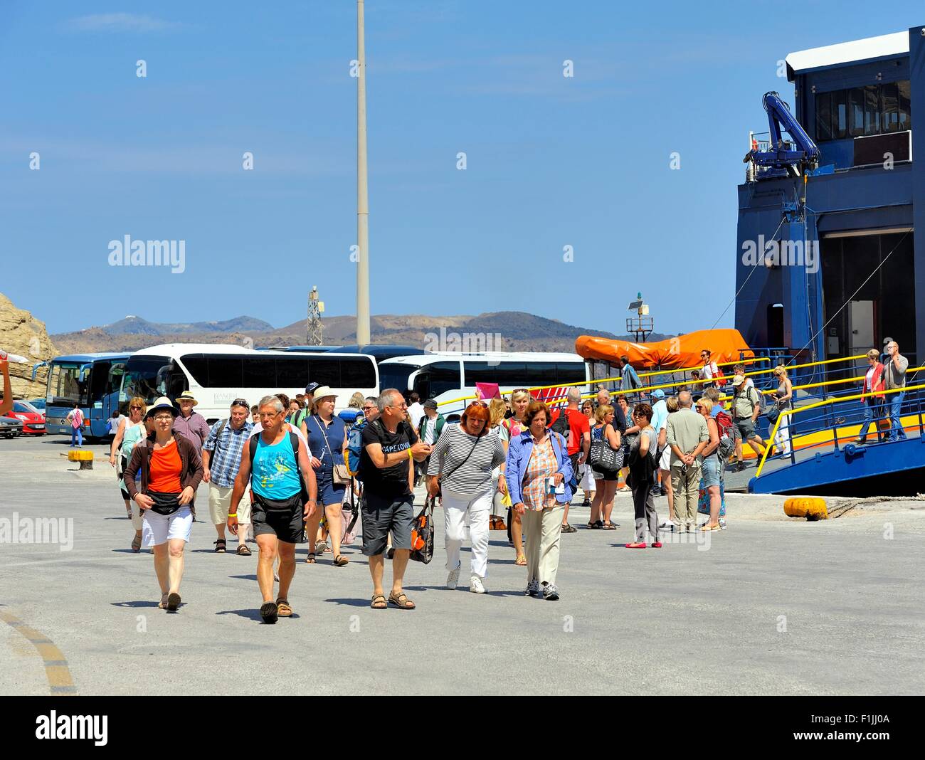 Ferry passengers arriving in the port of Ormos Athinios Santorini Greece Stock Photo
