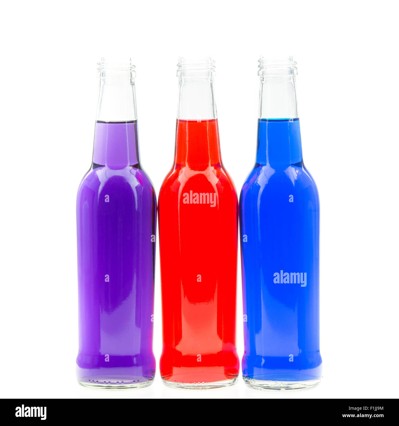 Three colorful bottles, isolated on white background Stock Photo - Alamy