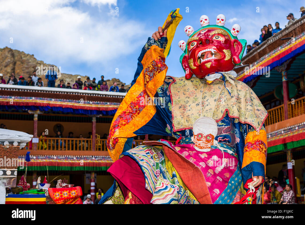 Monks with big wooden masks and colorful costumes are performing ritual dances at Hemis Festival in the courtyard of the Stock Photo