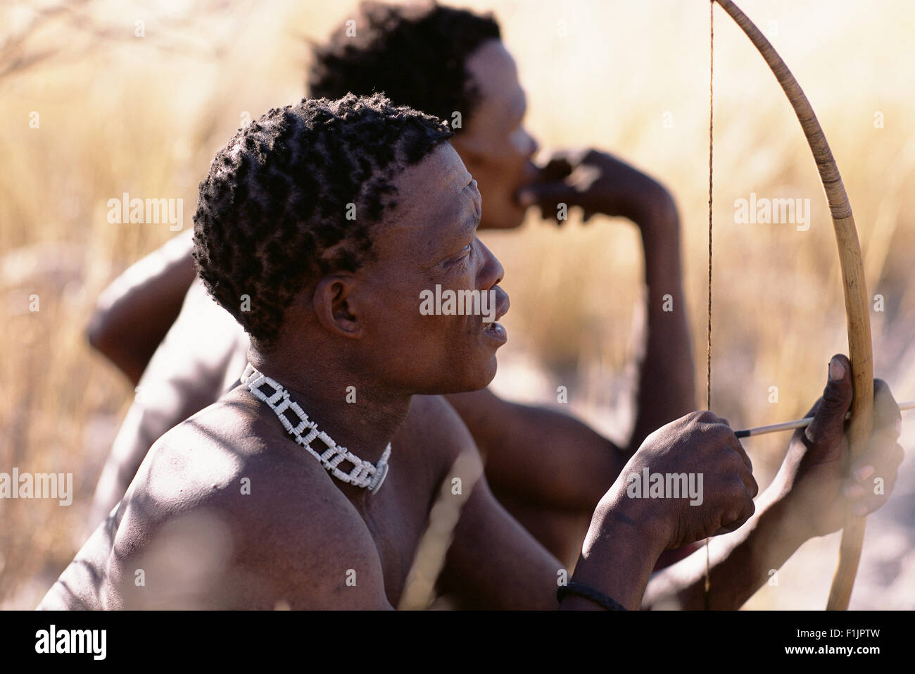 Bushman Hunters with Bow and Arrow, Namibia, Africa Stock Photo