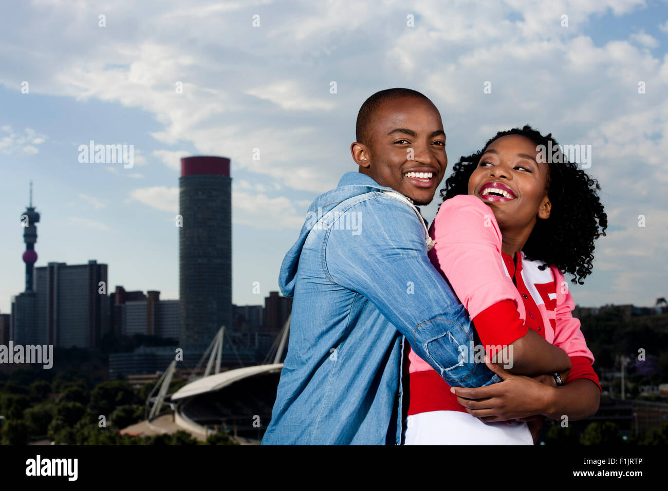 Young black couple stand in front of cityscape Stock Photo - Alamy