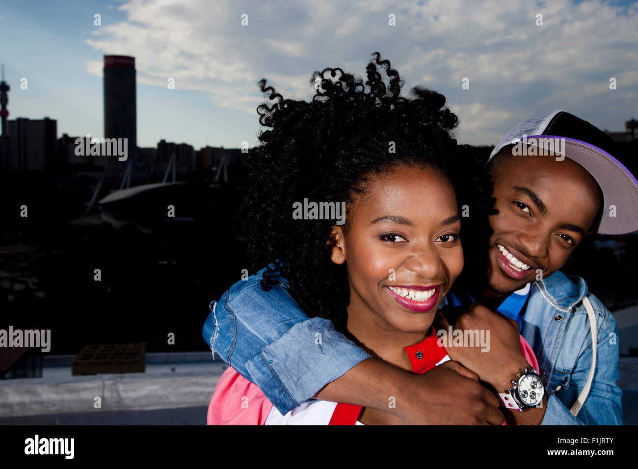 Young black couple stand in front of cityscape Stock Photo - Alamy